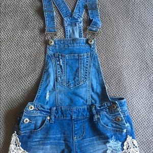Blue Jean overall shorts with lace details.